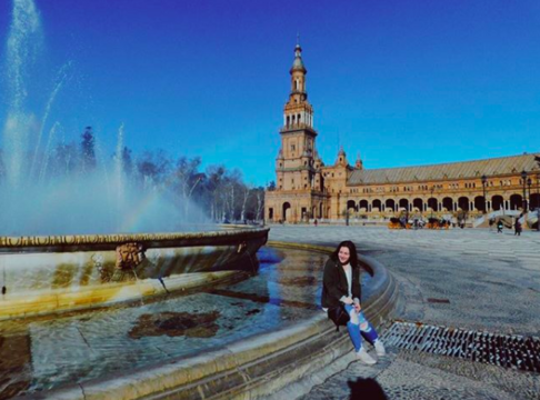 Female student in front of a water fountain - Seville, Spain