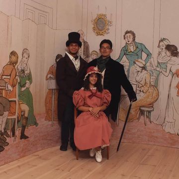 Female student with friends in front of a painted wall