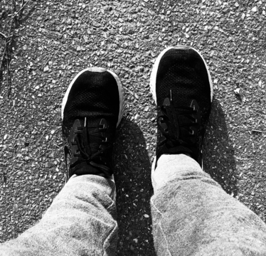 A black and white photo showing shoes.