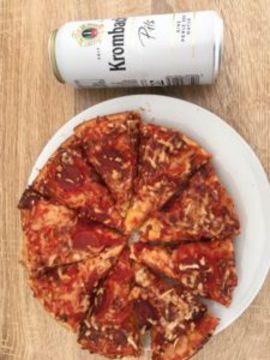 Ready frozen pizza and a can of beer.