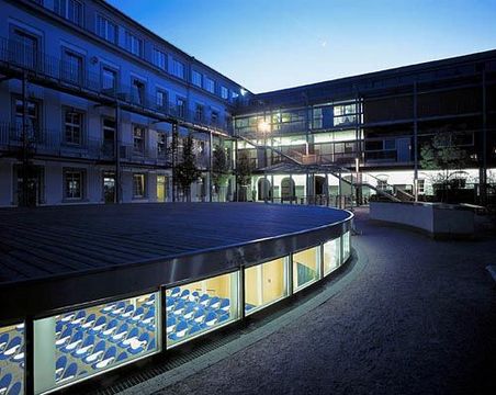 University courtyard at night, illuminated