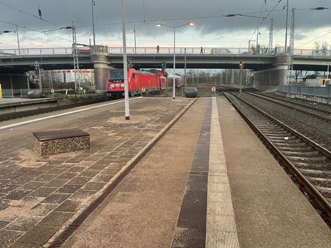 Two empty platforms, you can see an exiting train.