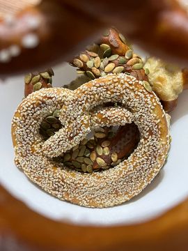 A bretzel with sesame on top of it.