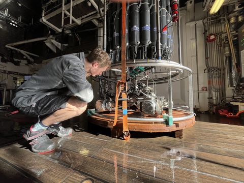 A PhD student looking at a CTD rosette and attached instrumentation